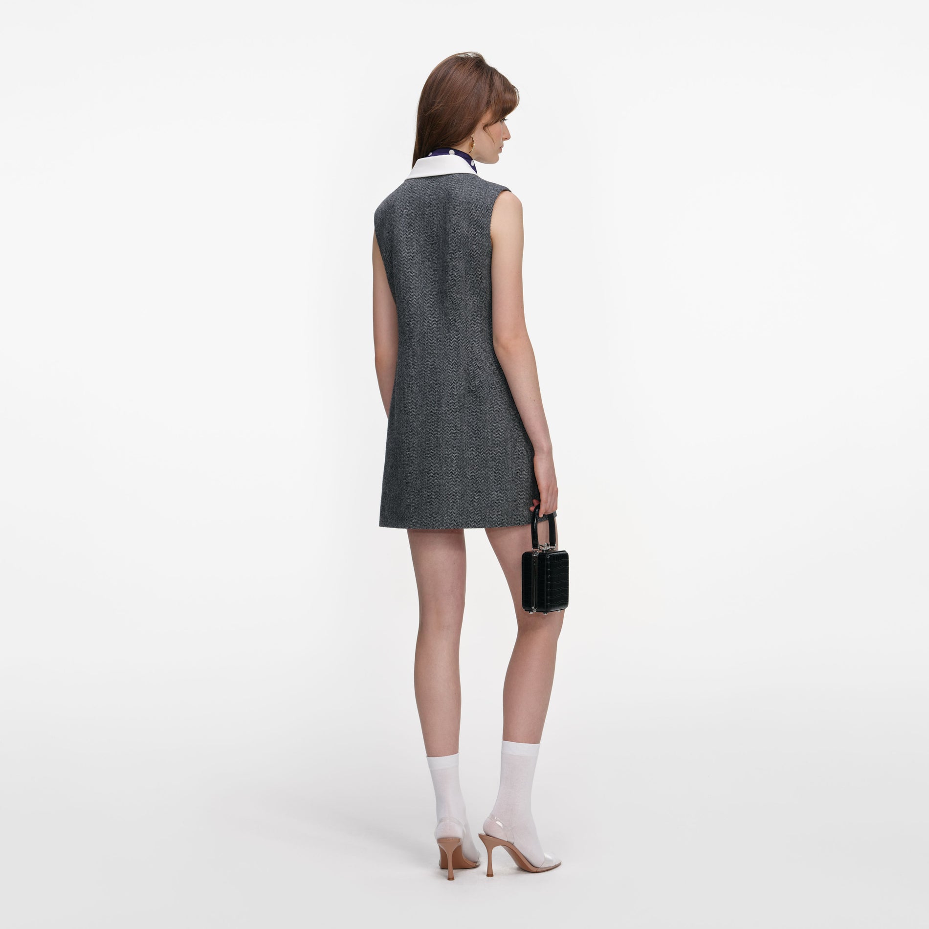 Back view of a woman wearing the Grey Herringbone Scarf Detail Mini Dress