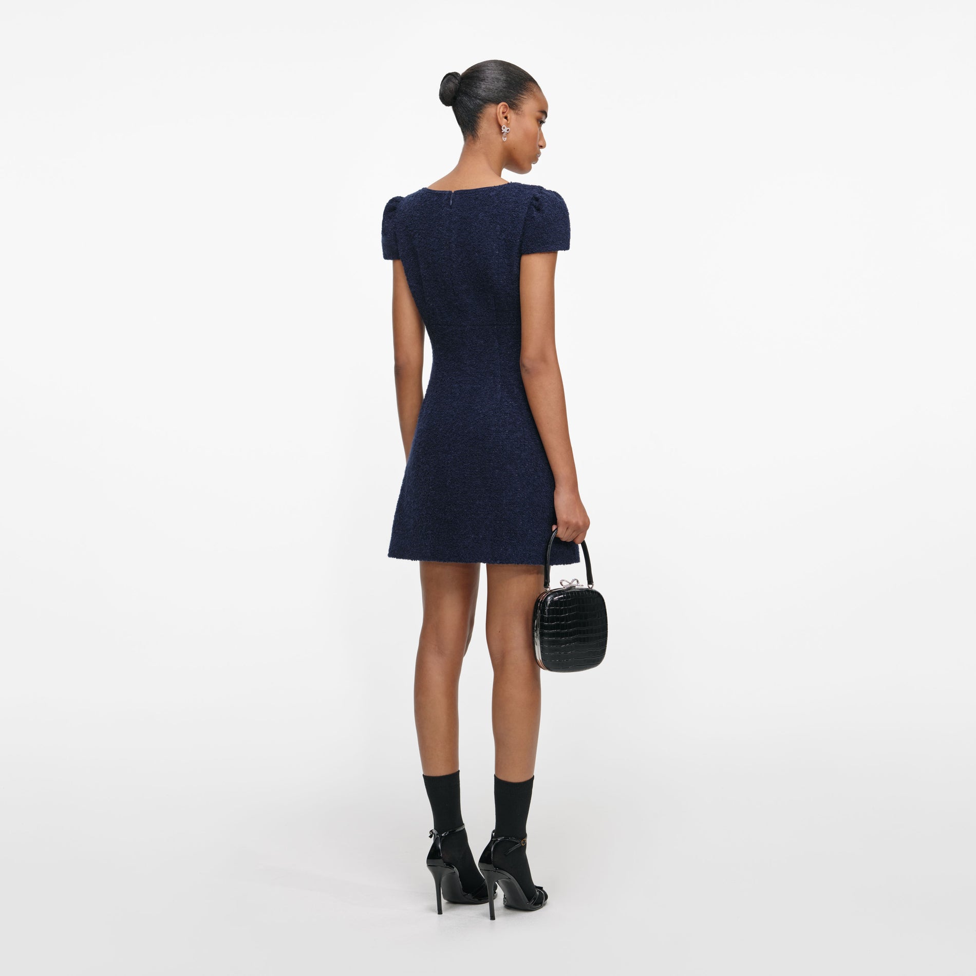 Back view of a woman wearing the Navy Textured Boucle Mini Dress