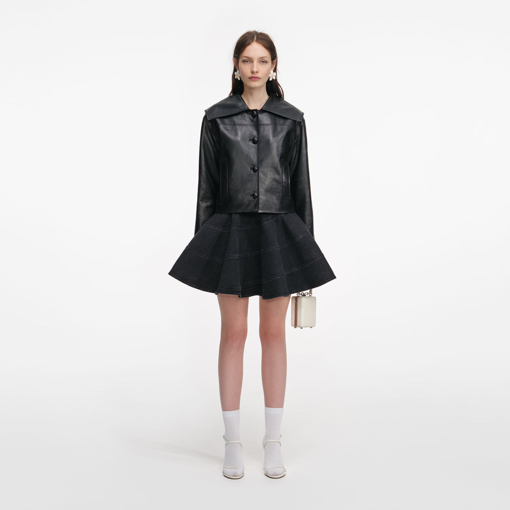 A close up of a woman wearing the Black Leather Contrast Collar Jacket