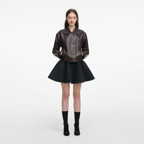 Front view of a woman wearing the Brown Cropped Leather Jacket