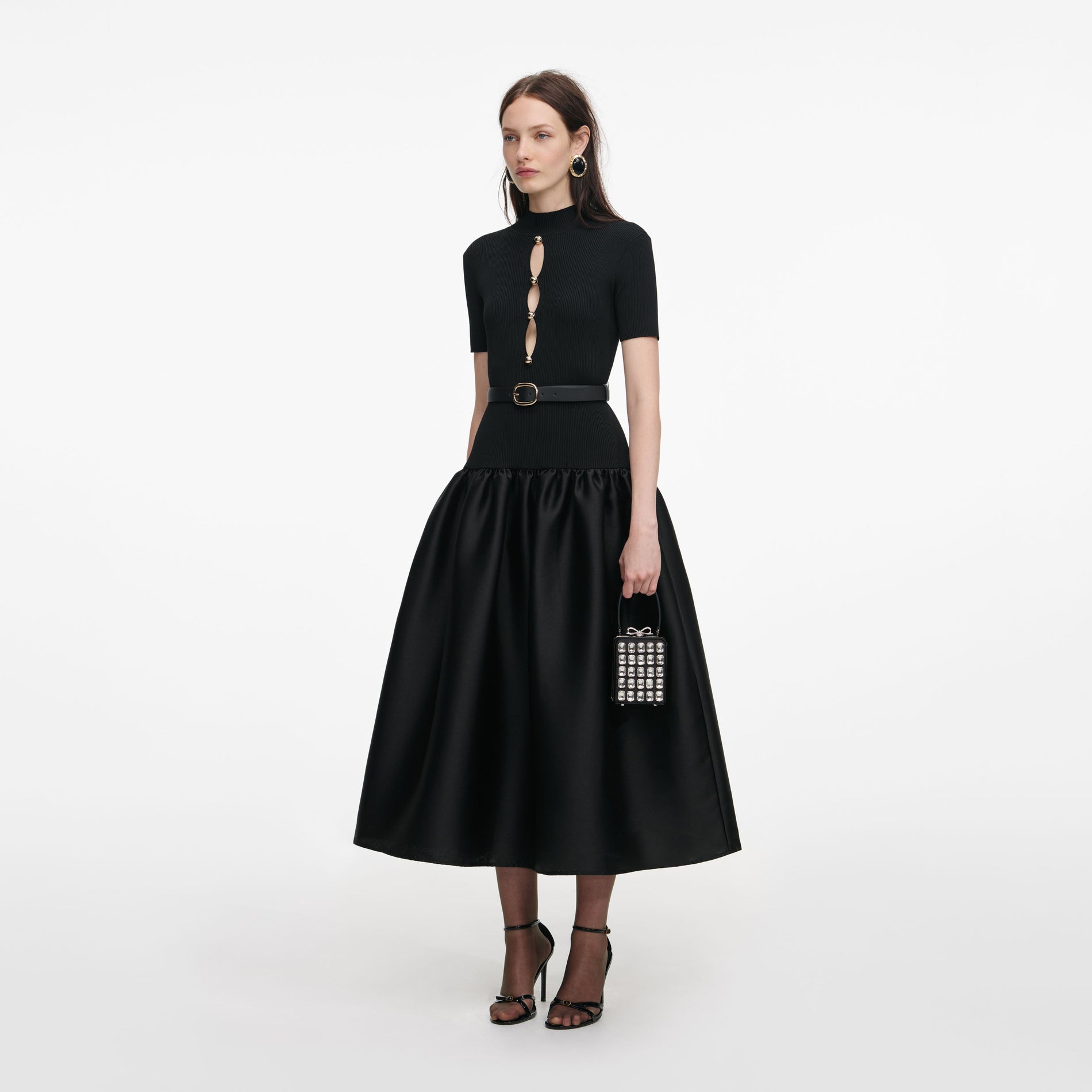 Side view of a woman wearing the Black Knit Taffeta Midi Dress