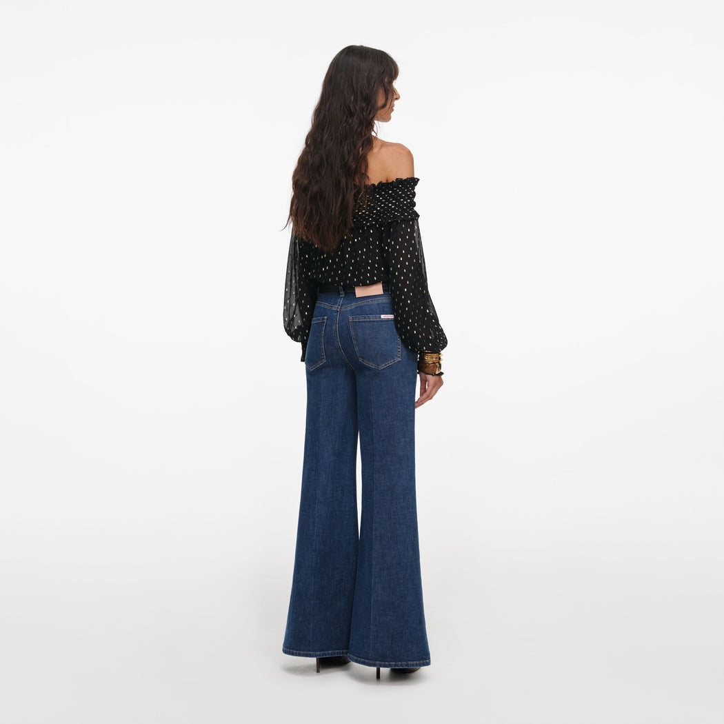 Back view of a woman wearing the Black And Gold Chiffon Top