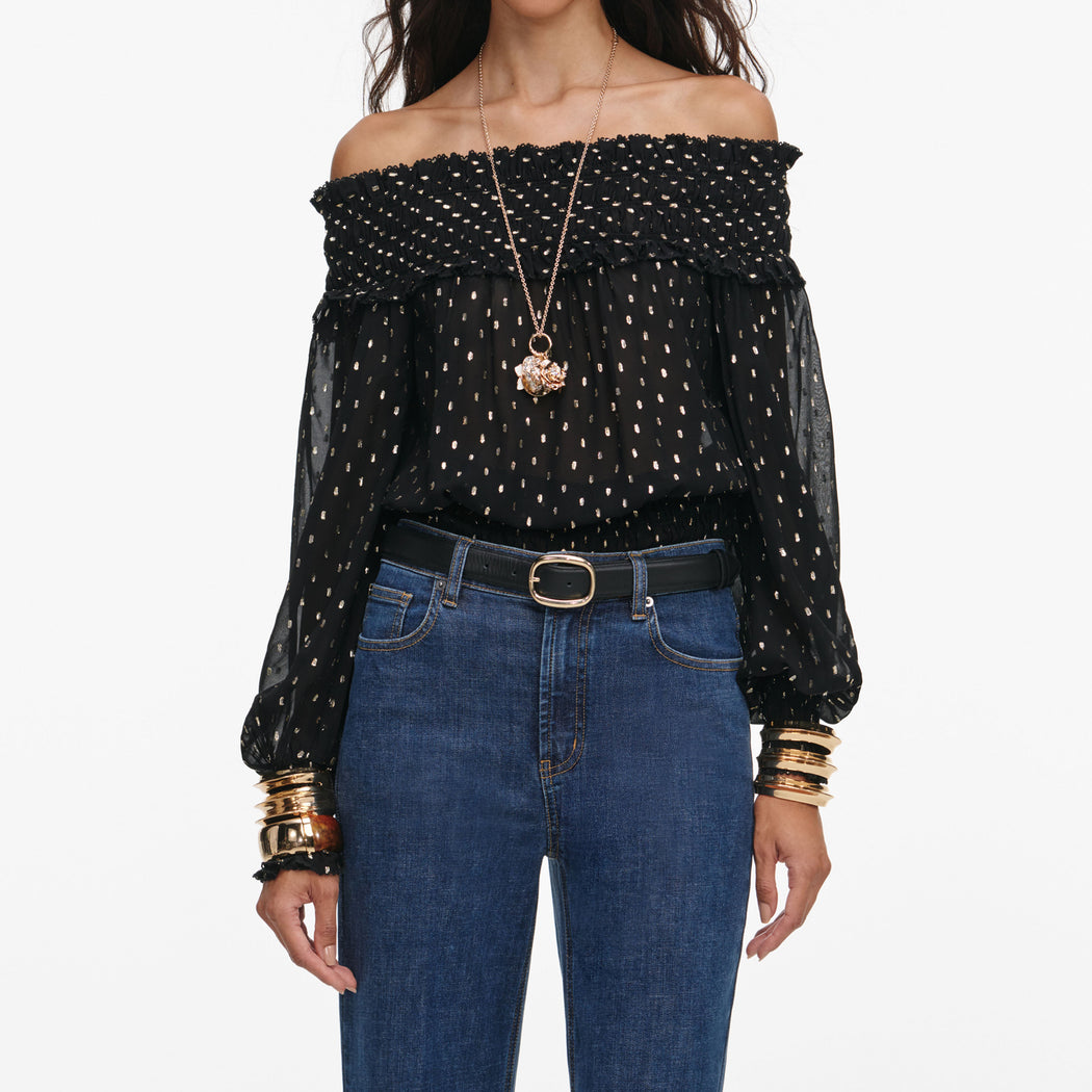 A close up of a woman wearing the Black And Gold Chiffon Top