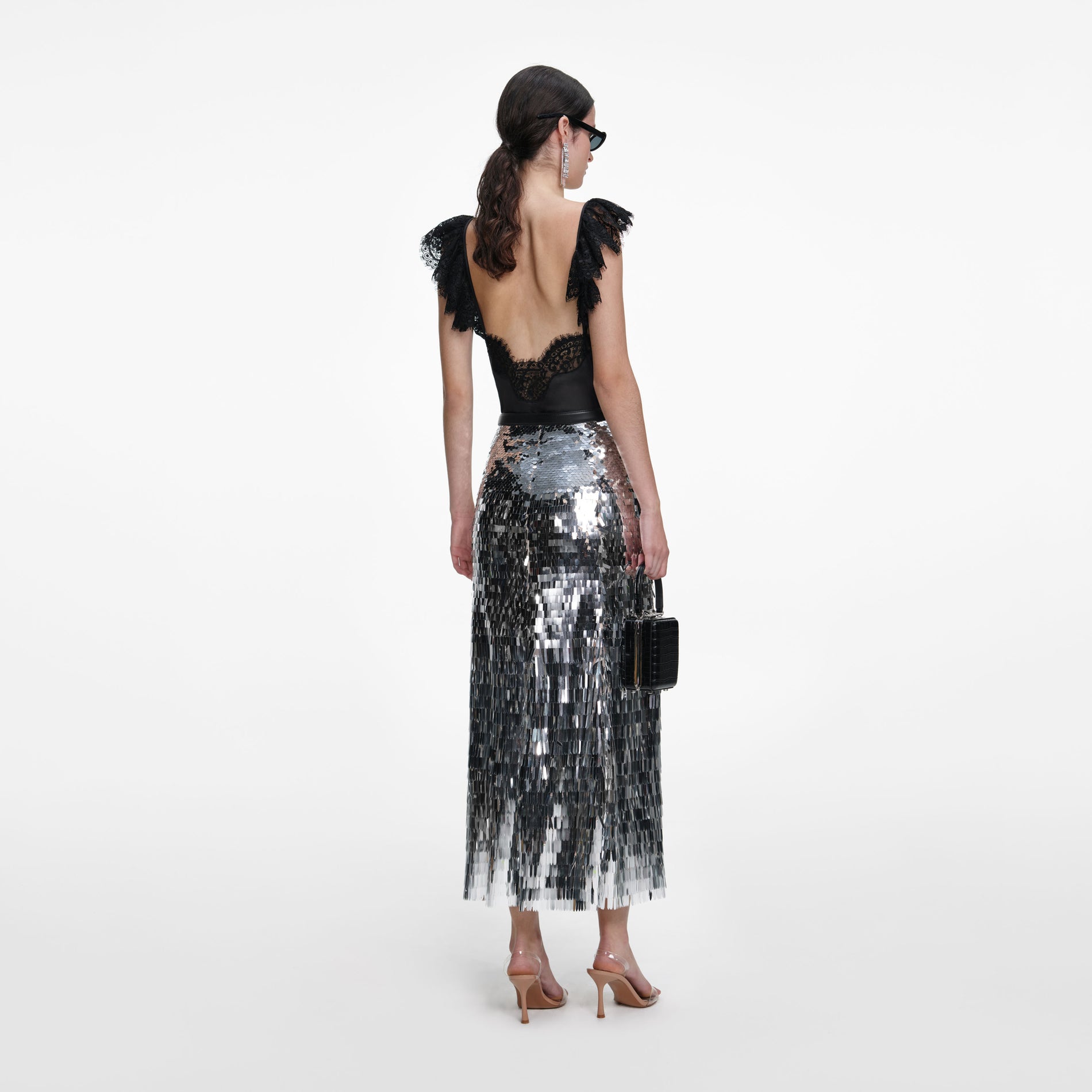 Back view of a woman wearing the Silver Gradient Sequin Midi Skirt