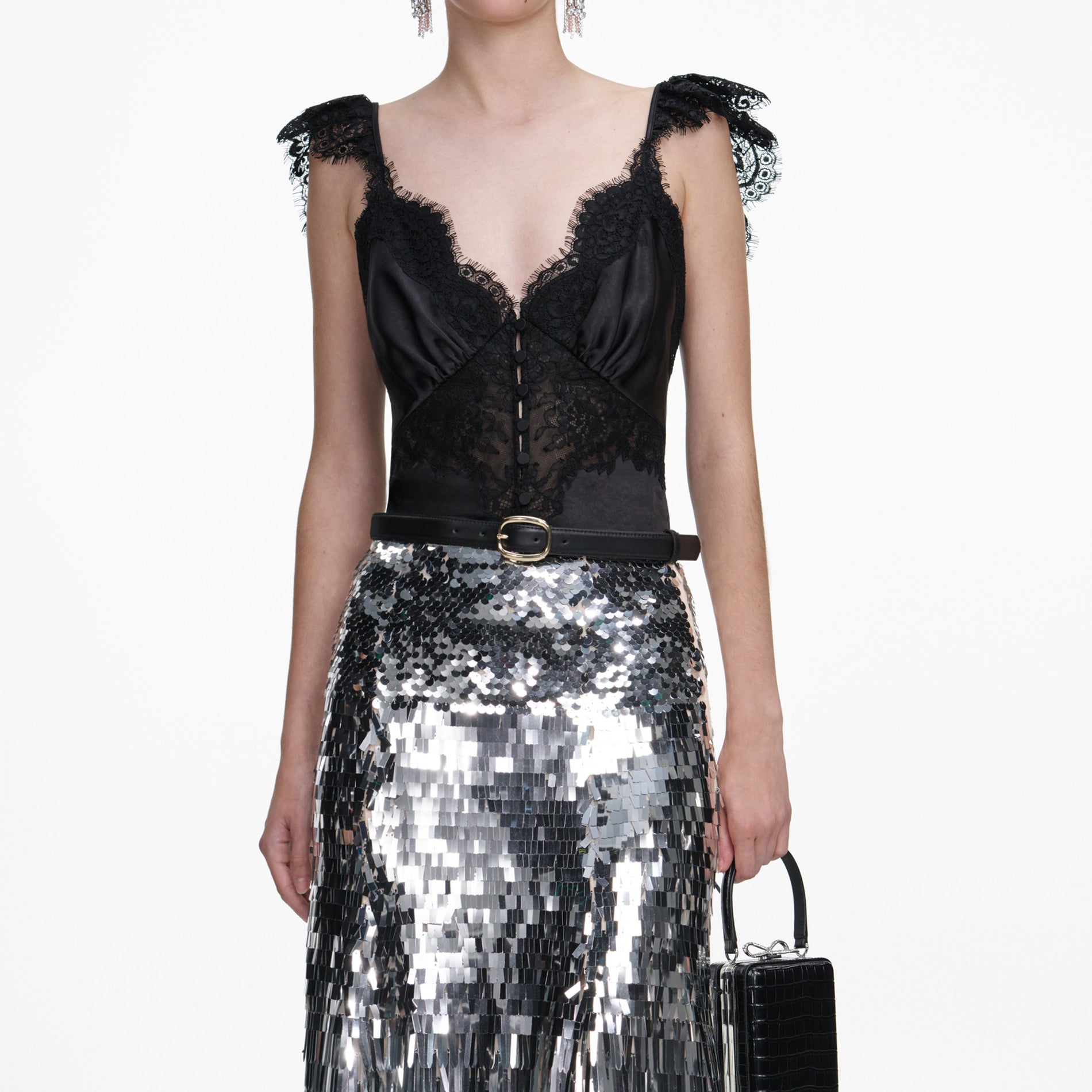 A close up of a woman wearing the Silver Gradient Sequin Midi Skirt