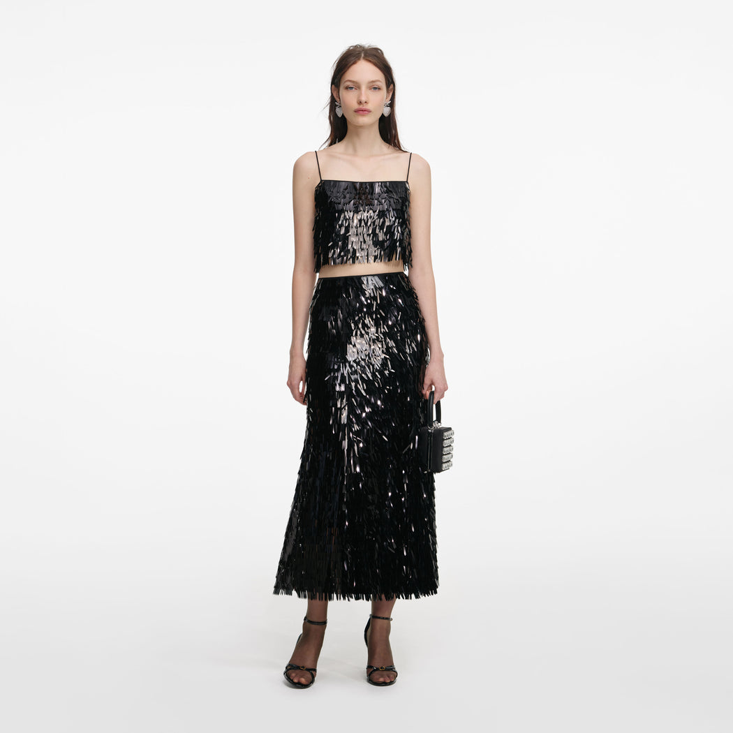 Front view of a woman wearing the Black Sequin Midi Skirt