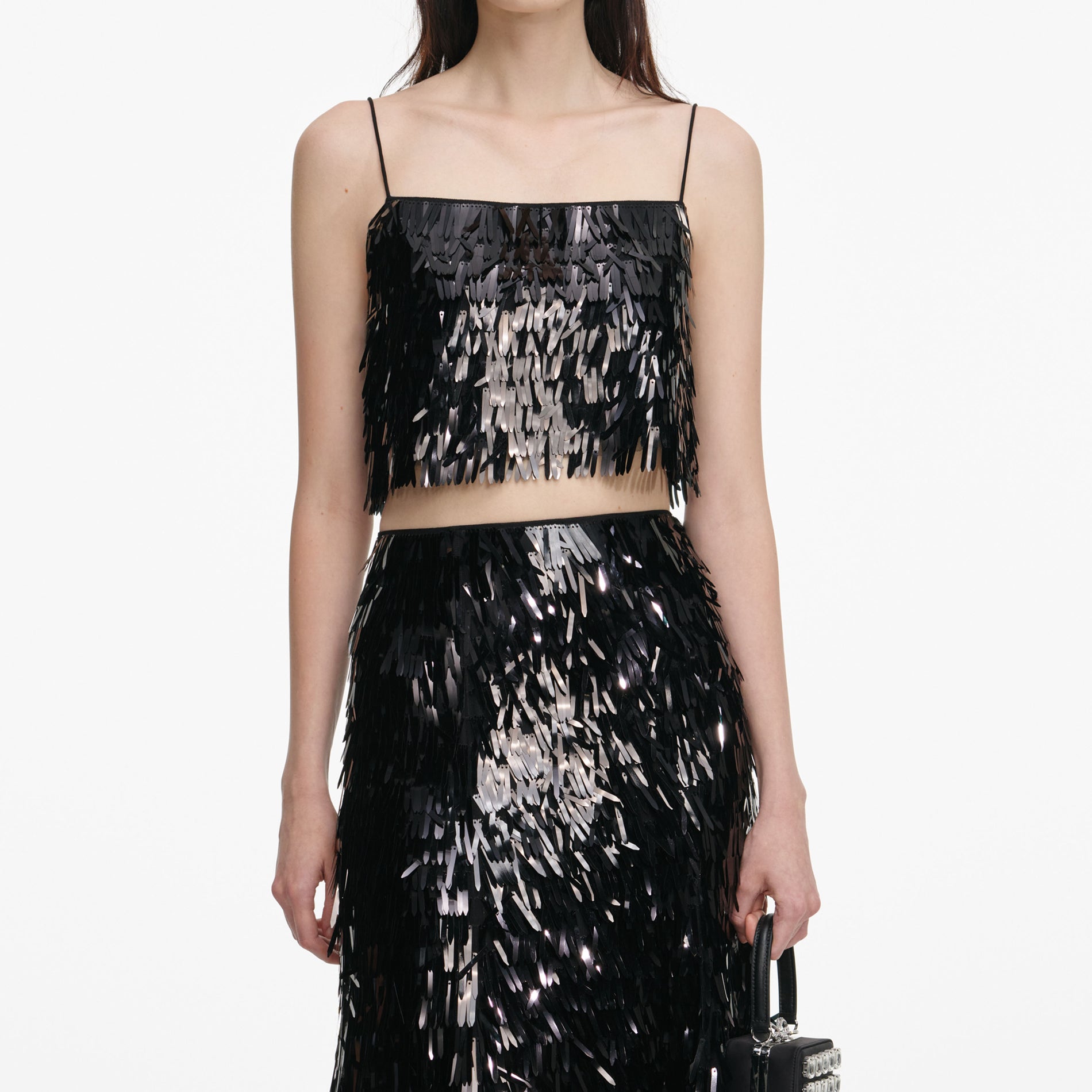 A close up of a woman wearing the Black Sequin Midi Skirt