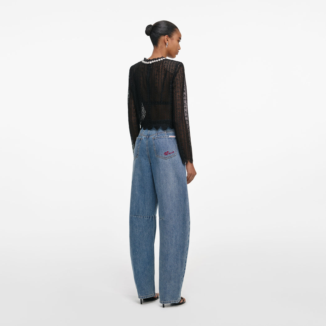 Back view of a woman wearing the Black Organza Lace Top