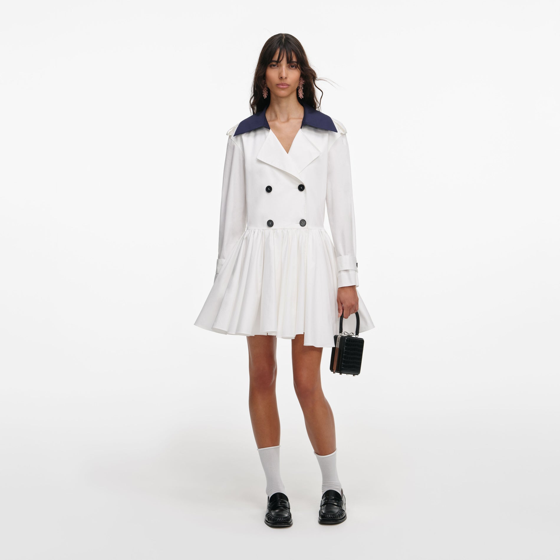 Front view of a woman wearing the White Cotton Double Breasted Mini Dress