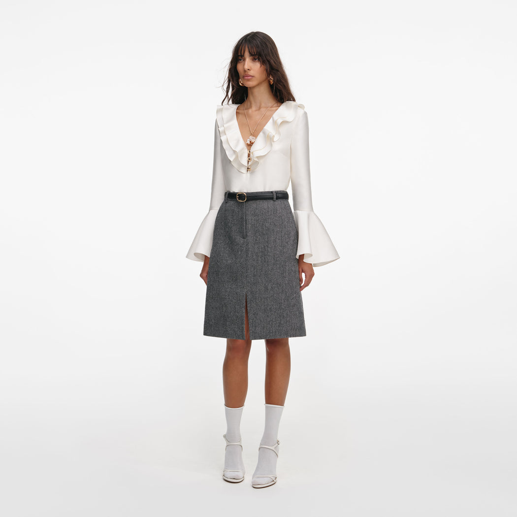 Side view of a woman wearing the Cream Taffeta Ruffle Top