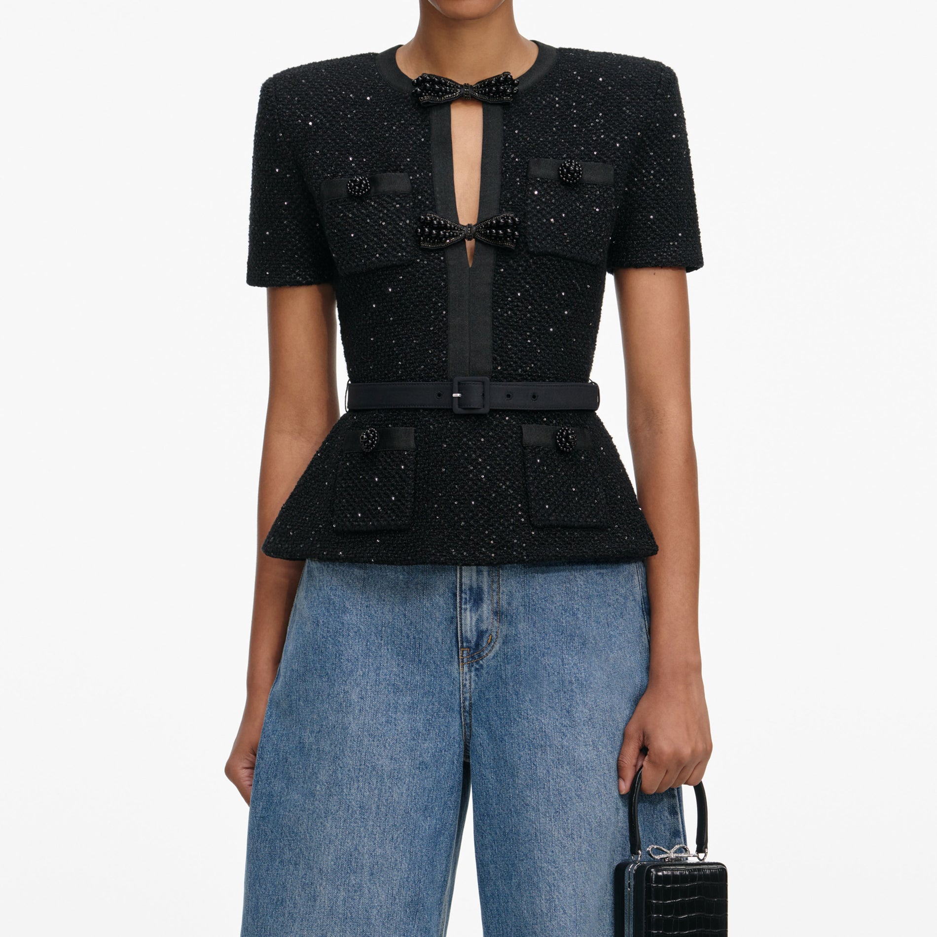 A close up of a woman wearing the Black Sequin Knit Top