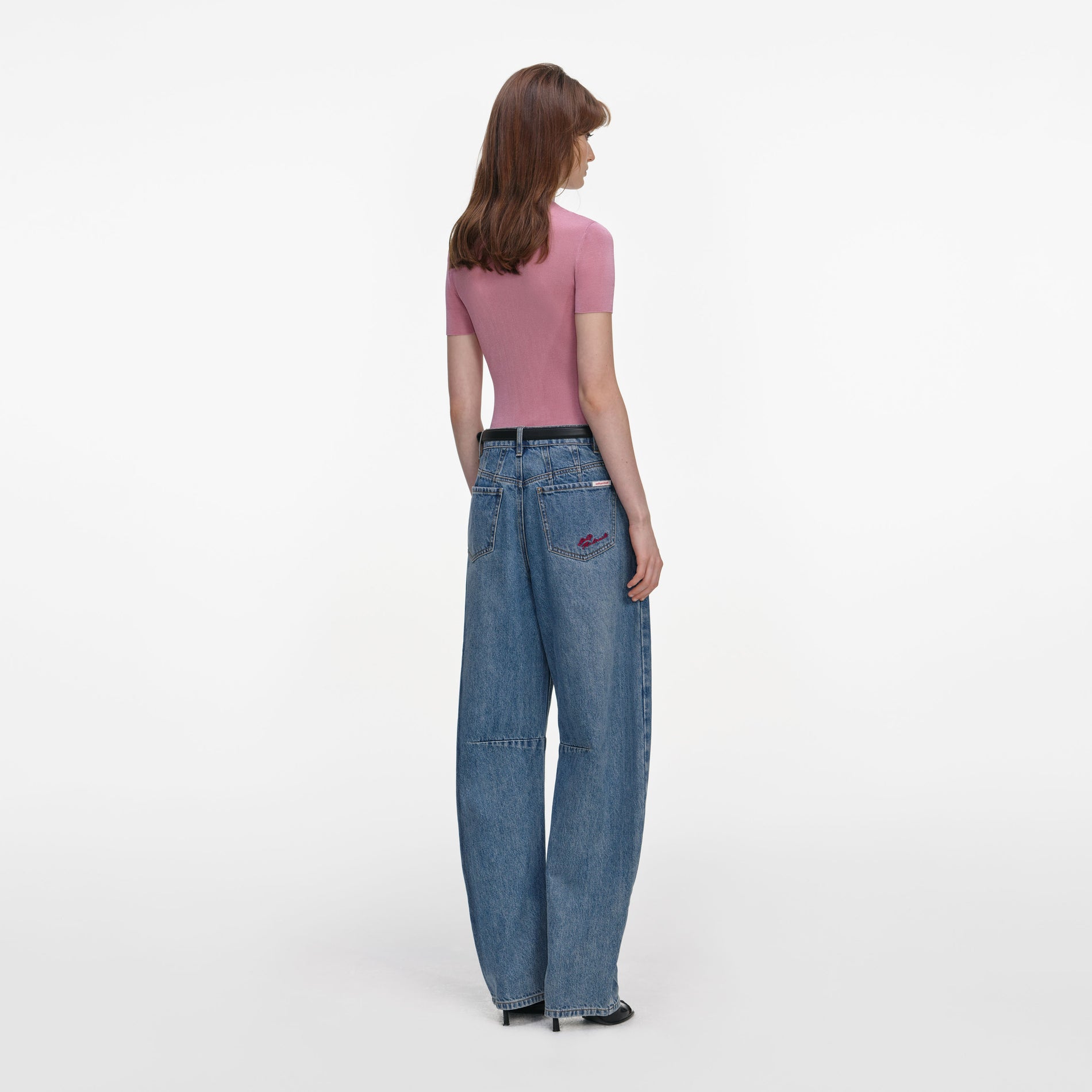 Back view of a woman wearing the Pink Short Sleeve Viscose Knit Top