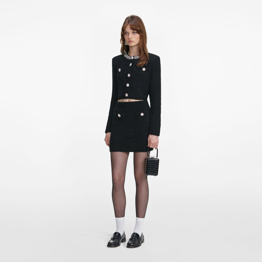Side view of a woman wearing the Black Crystal Trim Cardigan