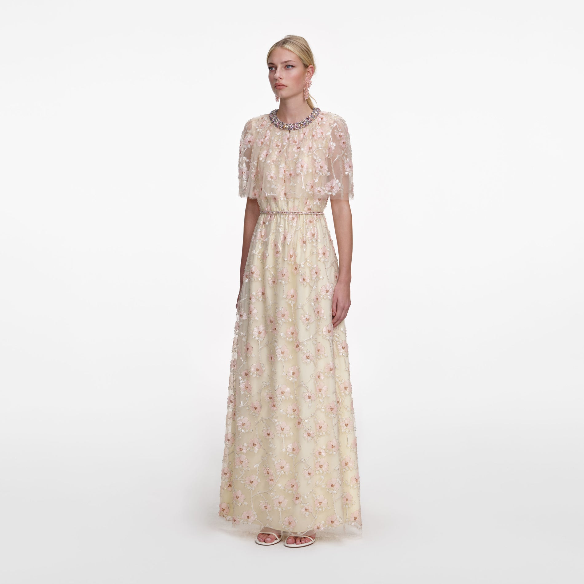 Side view of a woman wearing the Champagne Floral Embellished Maxi Dress