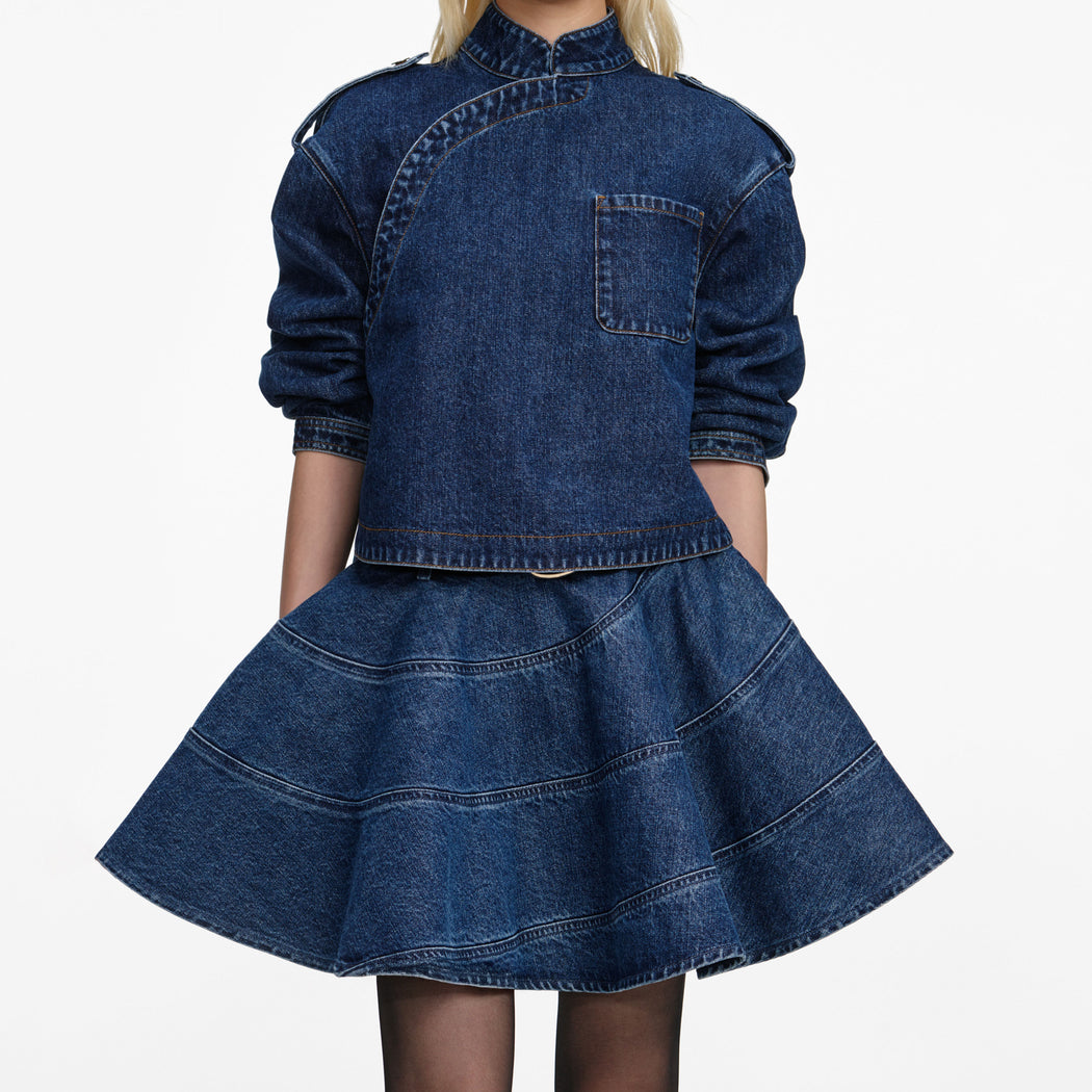 A close up of a woman wearing the Denim Asymmetric Shirt