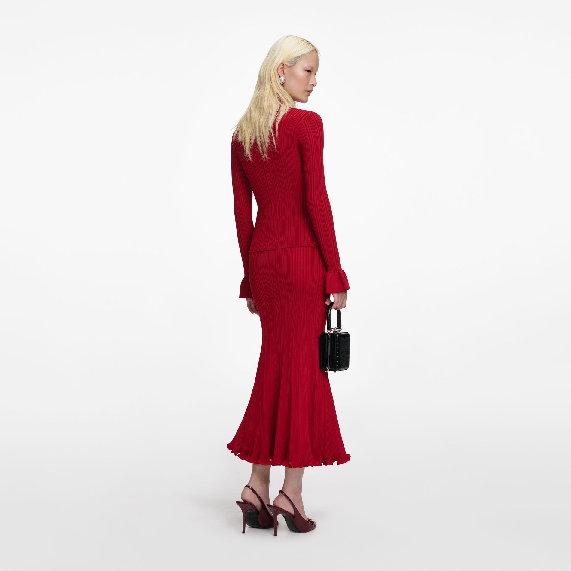 Back view of a woman wearing the Red Viscose Knit Midi Skirt