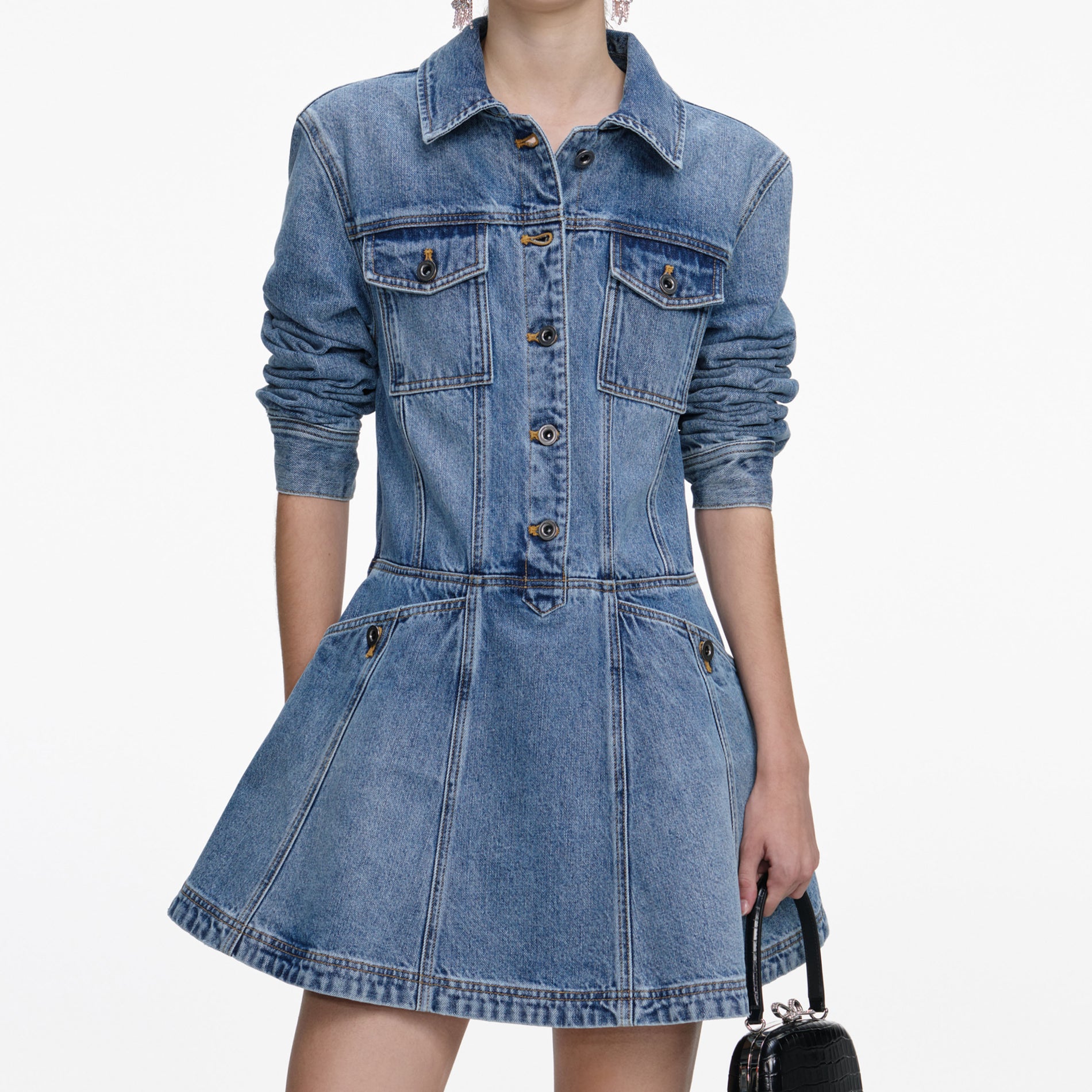 A close up of a woman wearing the Denim Mini Shirt Dress