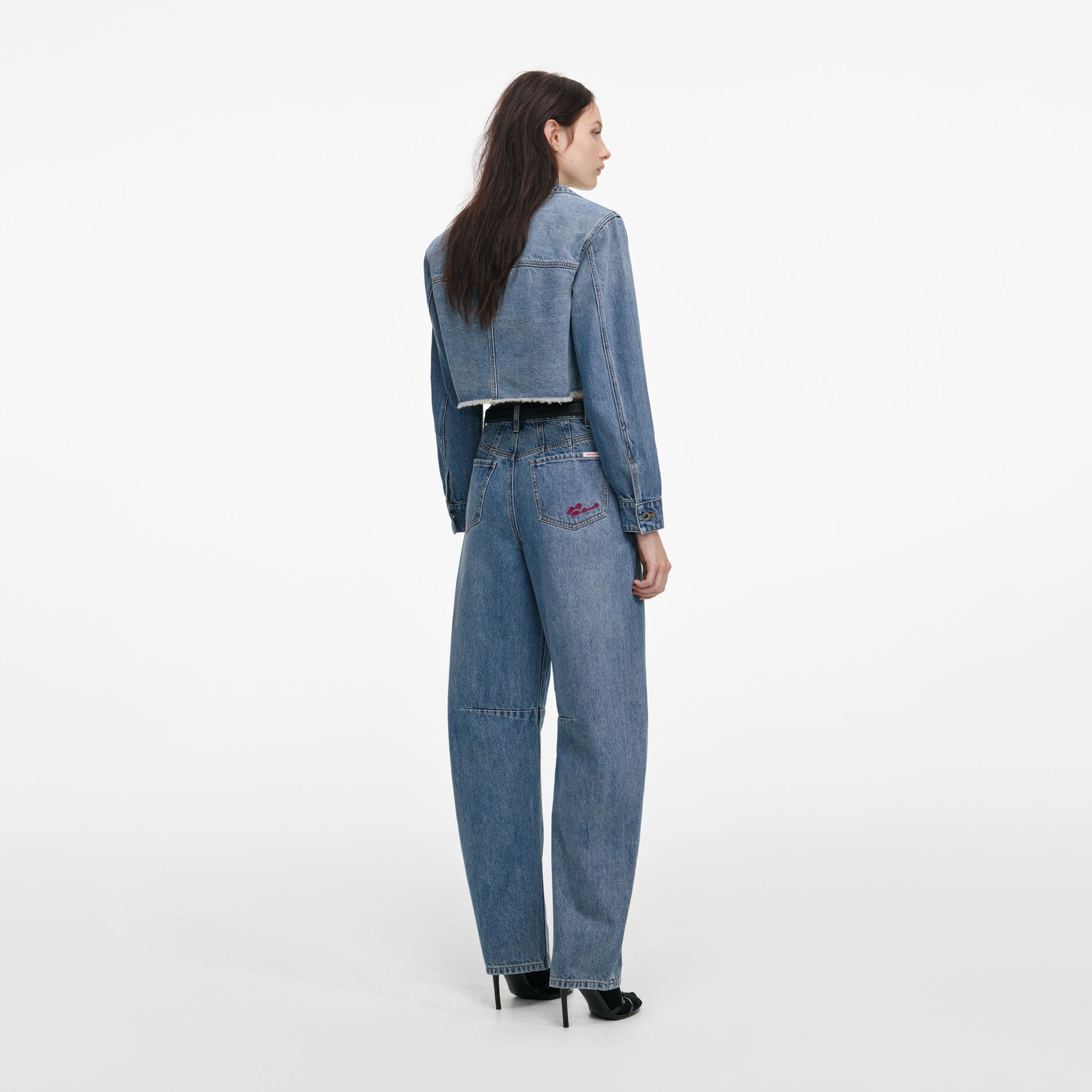 Back view of a woman wearing the Blue Barrel Leg Jeans