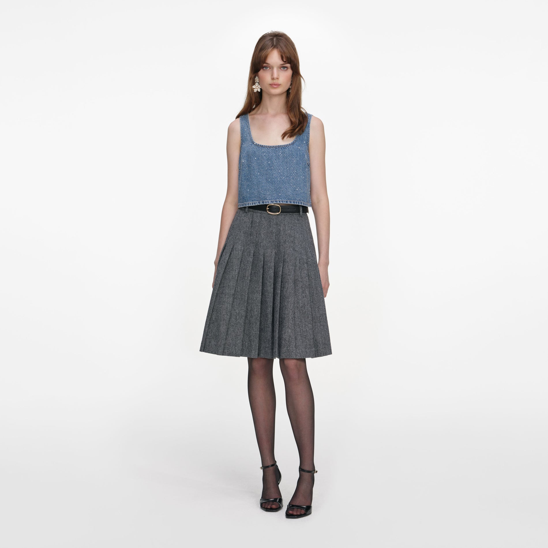 Front view of a woman wearing the Grey Herringbone Pleated Midi Skirt