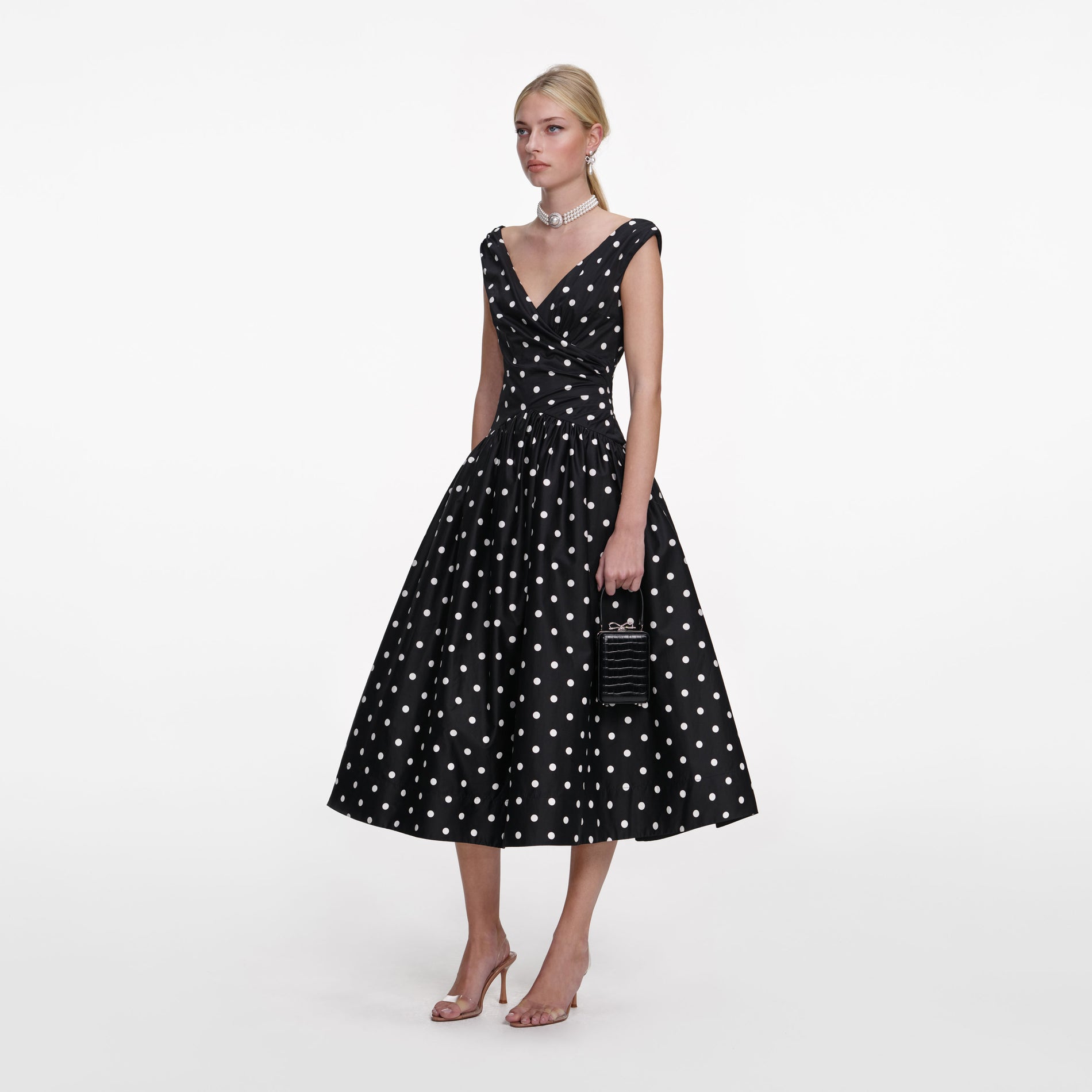 Side view of a woman wearing the Black Cotton Midi Dress