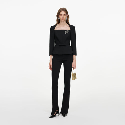 Front view of a woman wearing the Black Tailored Brooch Top