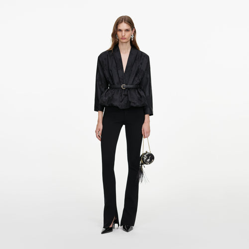 Front view of a woman wearing the Black Jacquard Peplum Top