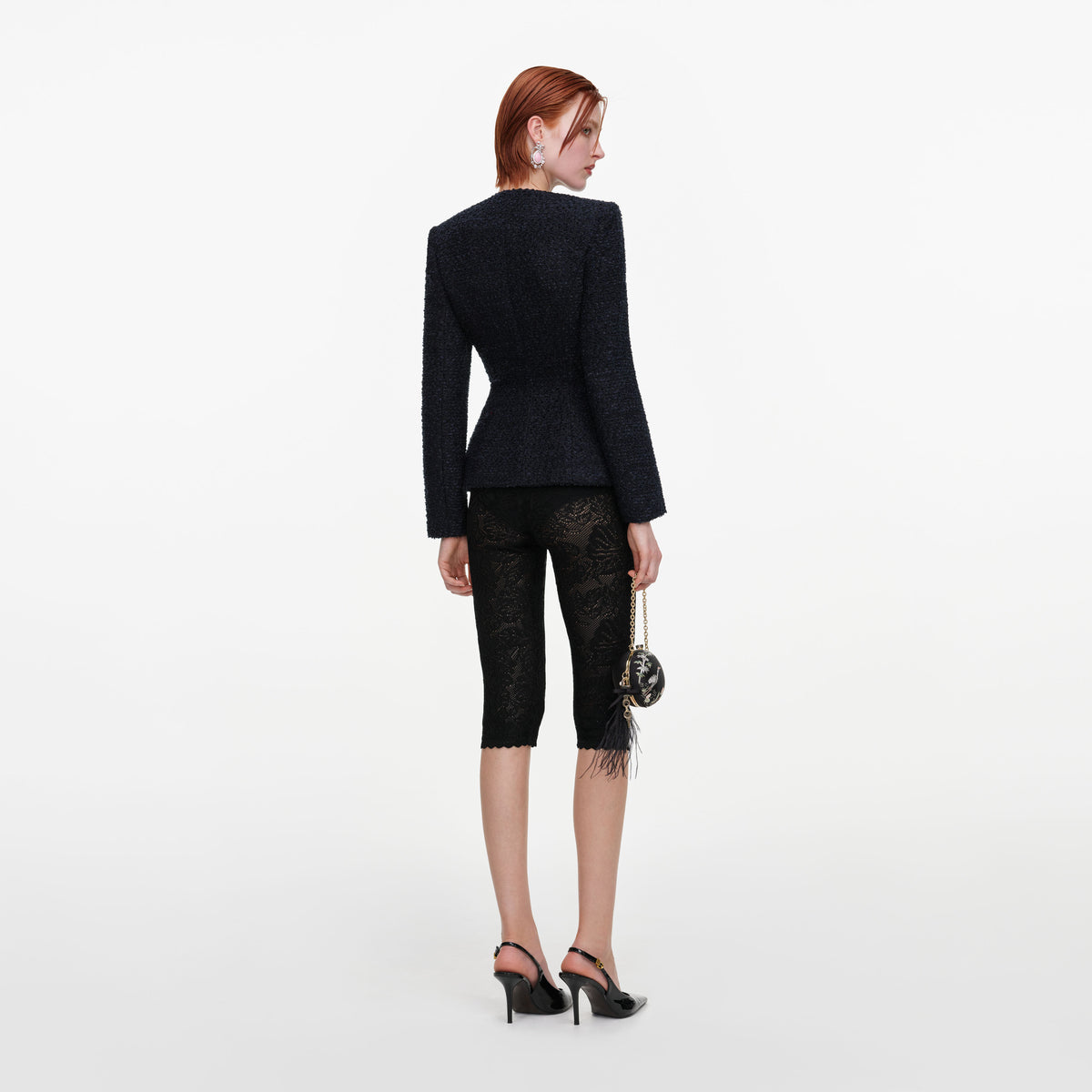 Back view of a woman wearing the Navy Boucle Jacket