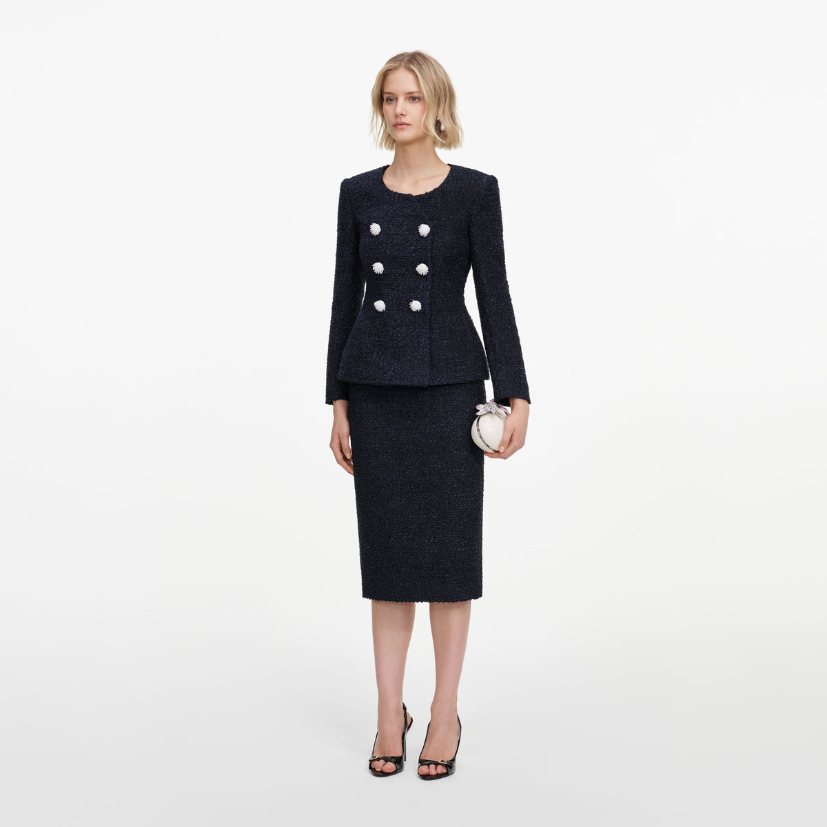 Side view of a woman wearing the Navy Boucle Midi Dress