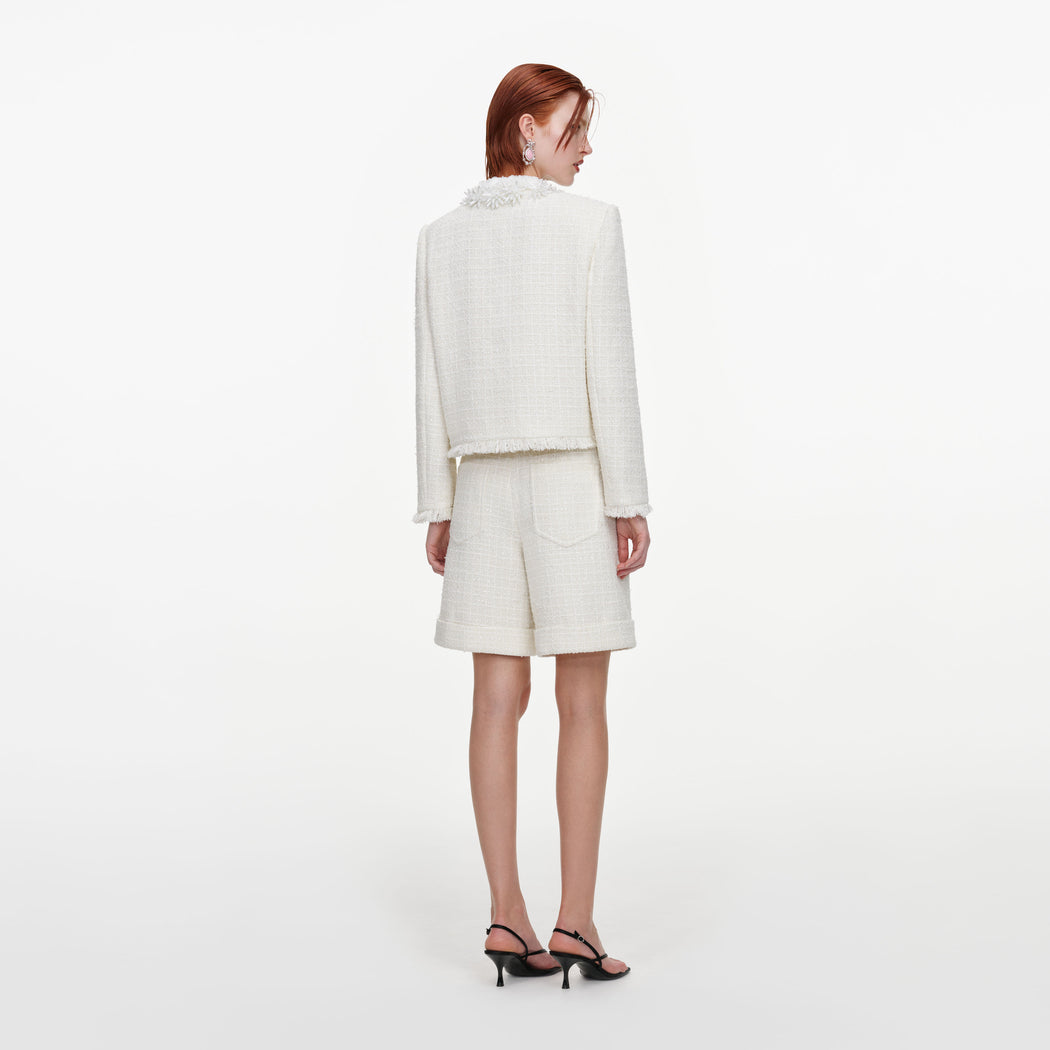 Back view of a woman wearing the Cream Sequin Boucle Pearl Trim Jacket