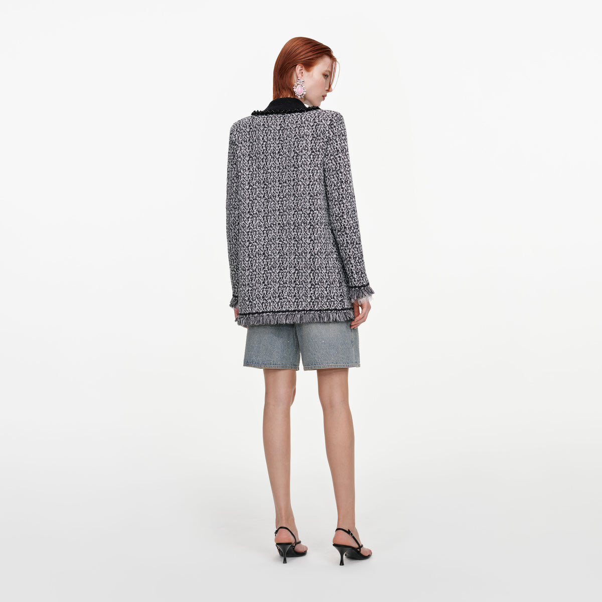 Back view of a woman wearing the Black And White Textured Knit Cardigan