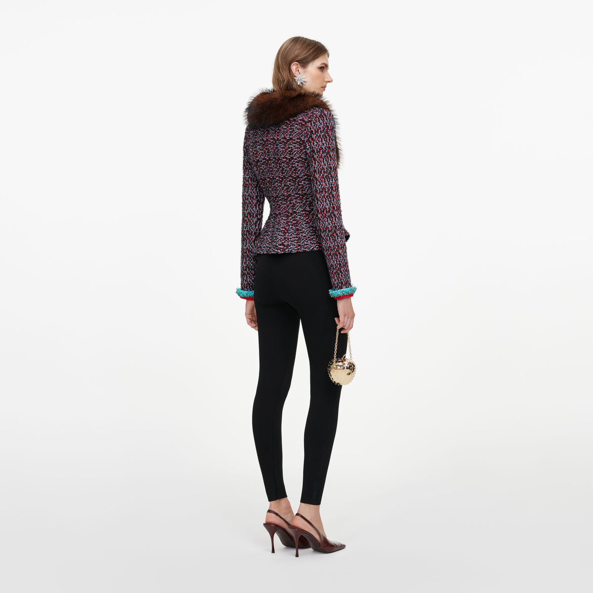 Back view of a woman wearing the Multi Textured Knit Peplum Cardigan
