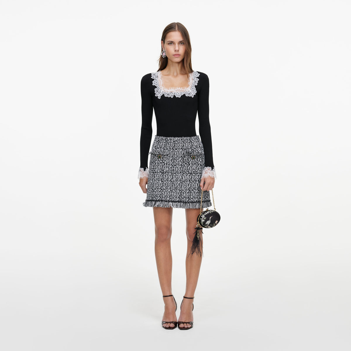 Front view of a woman wearing the Black And White Textured Knit Mini Skirt