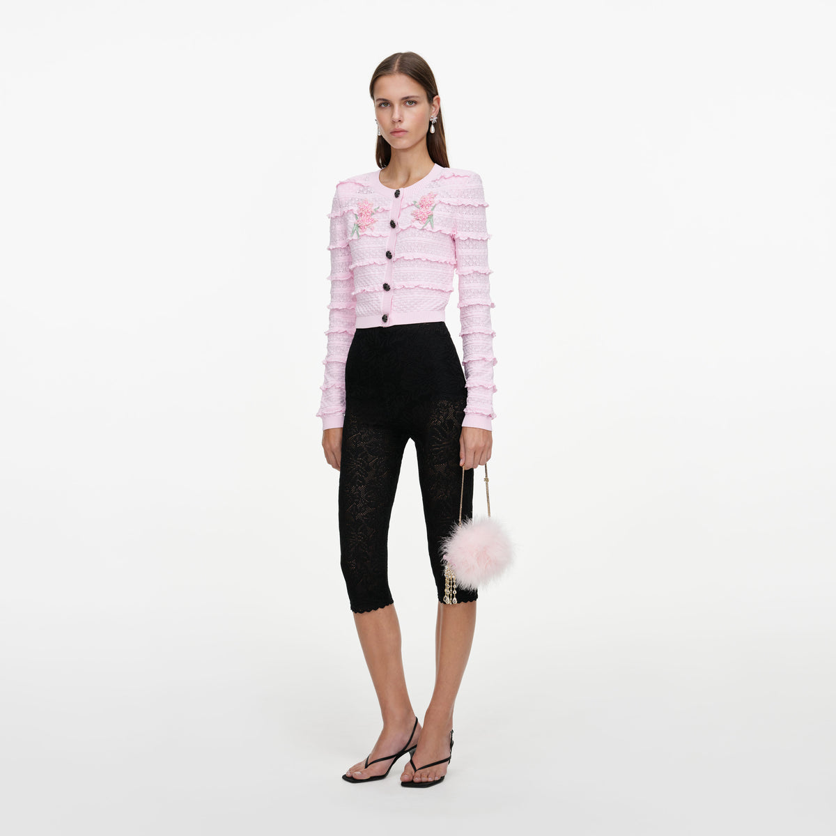 Side view of a woman wearing the Pink Flower Pointelle Knit Cardigan