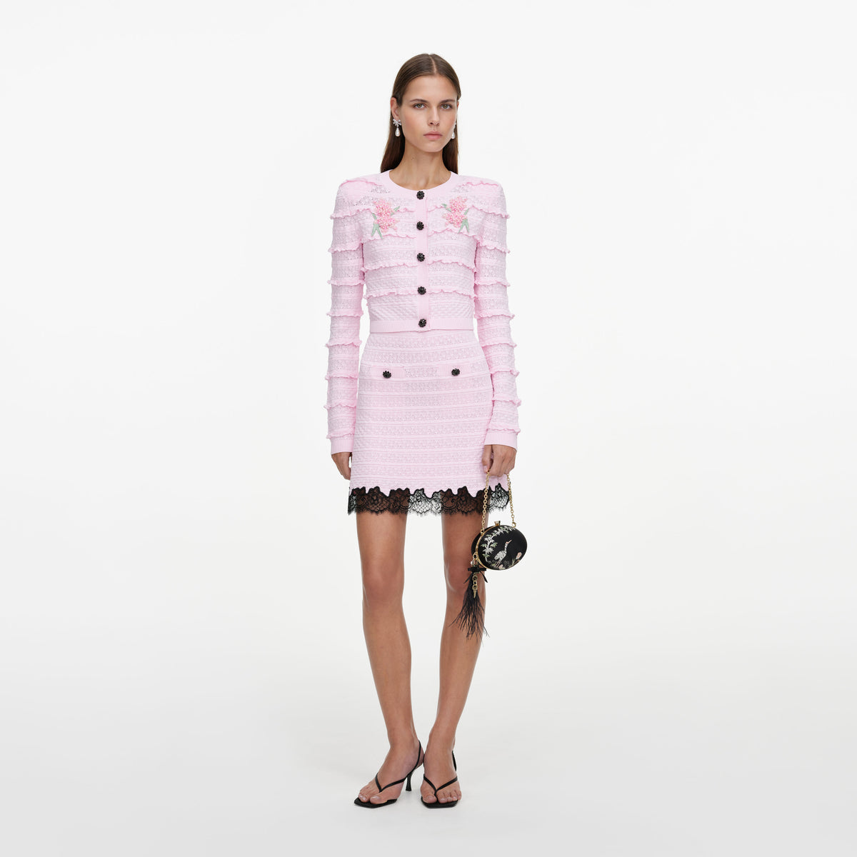 Front view of a woman wearing the Pink Pointelle Knit Skirt