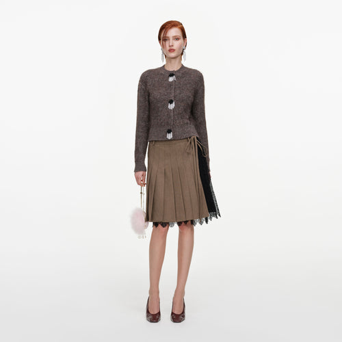 Front view of a woman wearing the Brown Twill Lace Pleated Midi Skirt