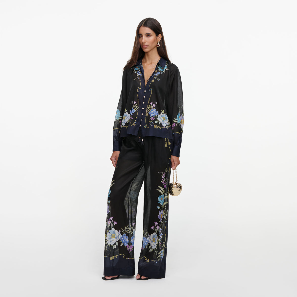 Side view of a woman wearing the Navy Floral Organza Trousers