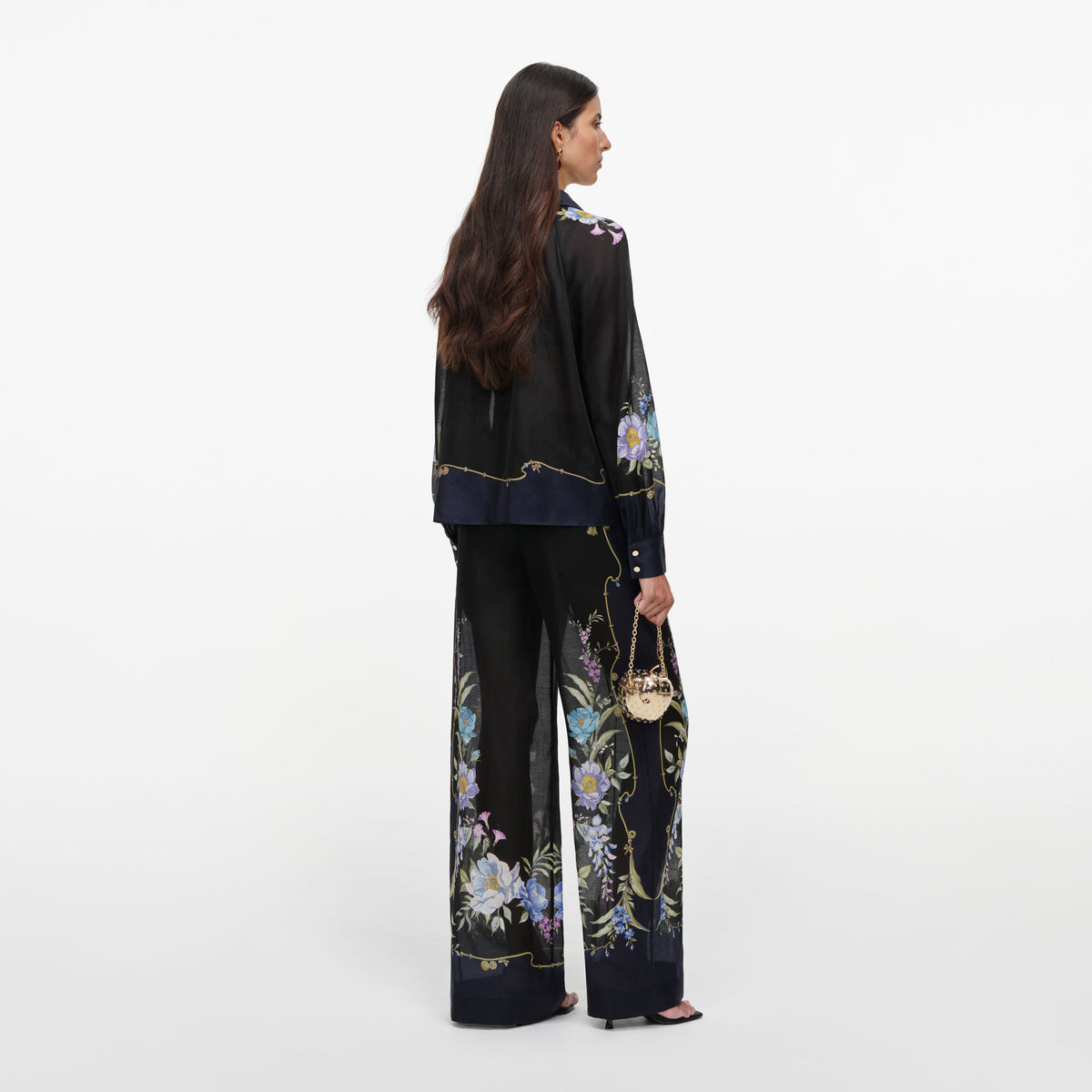 Back view of a woman wearing the Navy Floral Organza Trousers