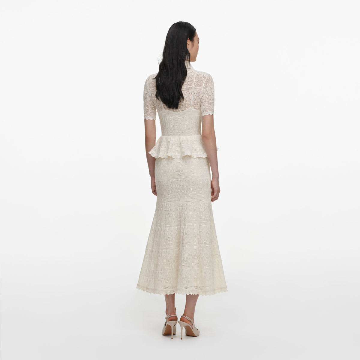 Back view of a woman wearing the Cream Pointelle Knit Wrap Peplum Midi Dress