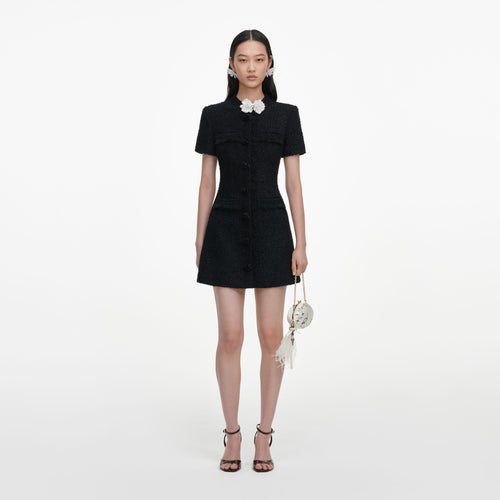 Front view of a woman wearing the Black Boucle Flower Mini Dress