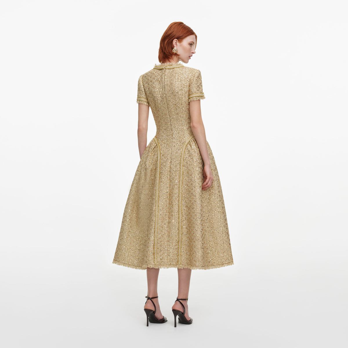 Back view of a woman wearing the Gold Sequin Boucle Midi Dress