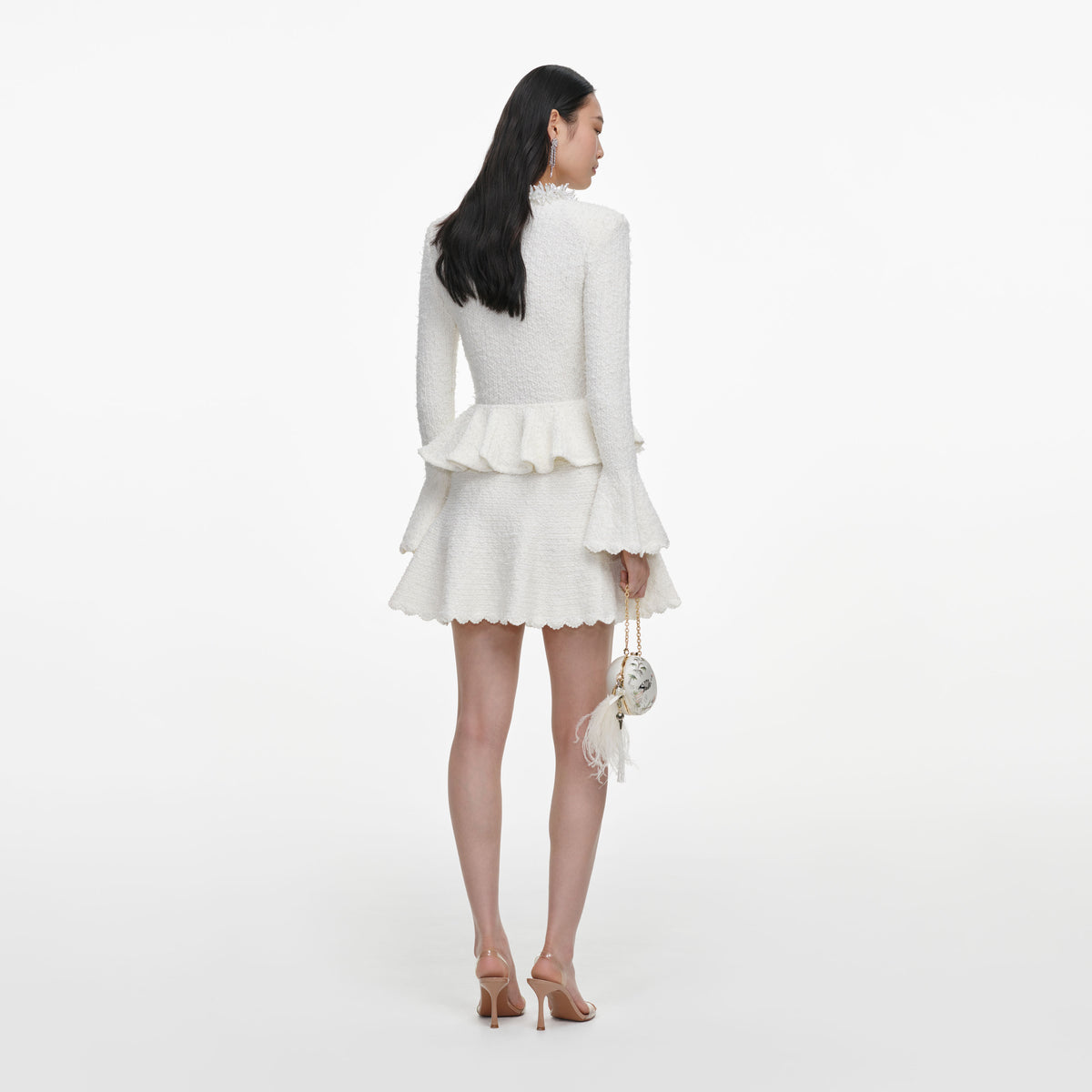 Back view of a woman wearing the White Textured Knit Mini Dress