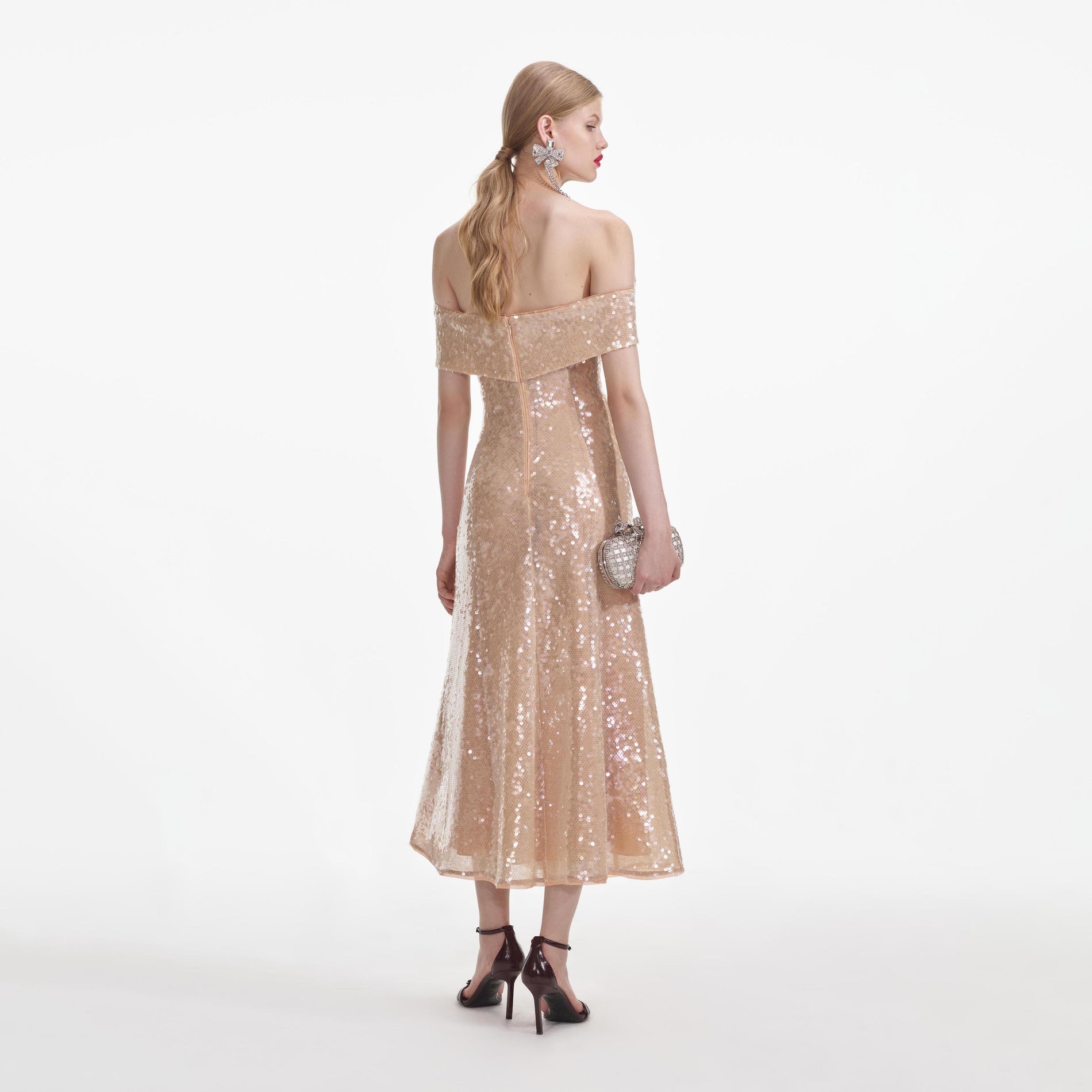 Back view of a woman wearing the Gold Sequin Off Shoulder Midi Dress