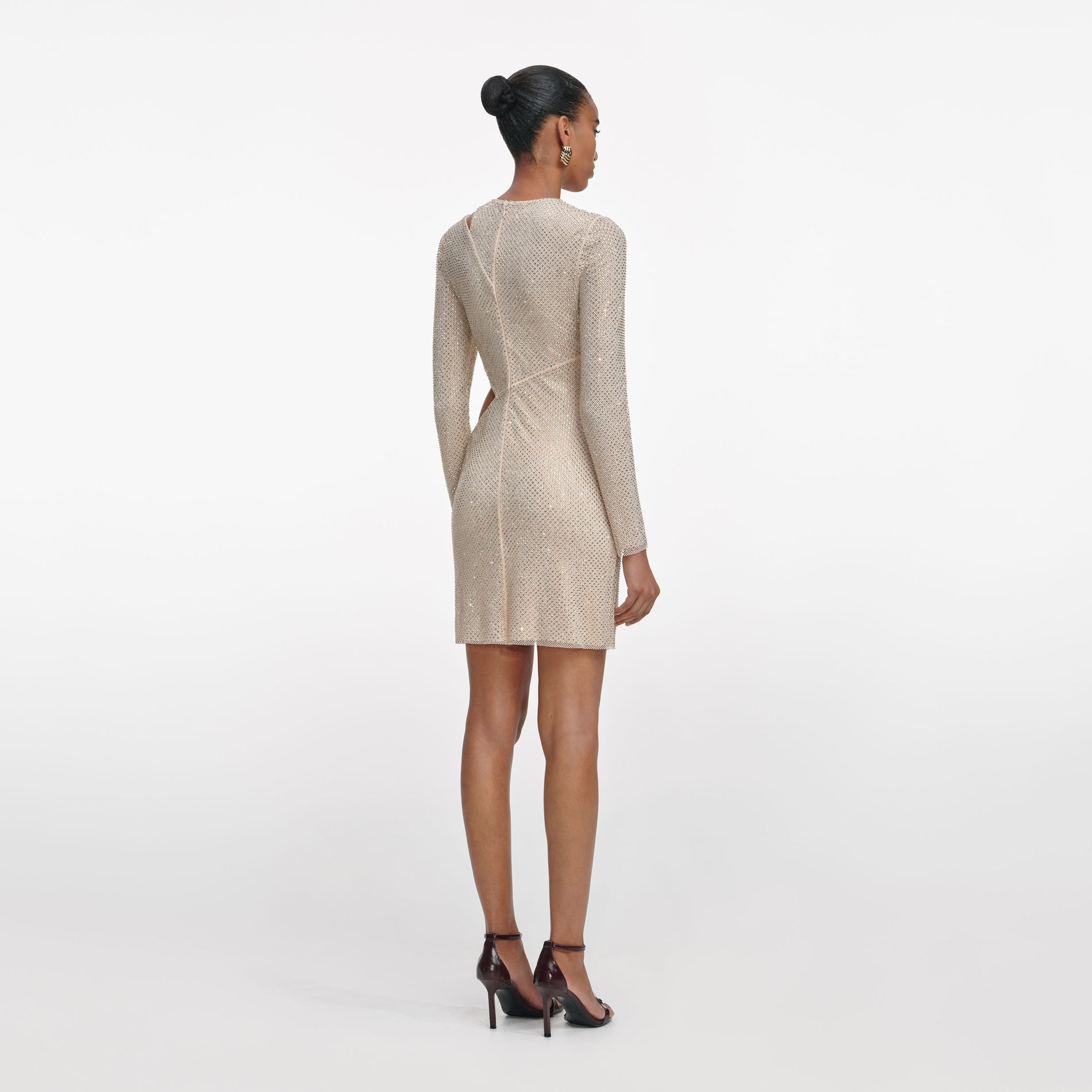 Back view of a woman wearing the Champagne Rhinestone Lace Trim Mini Dress