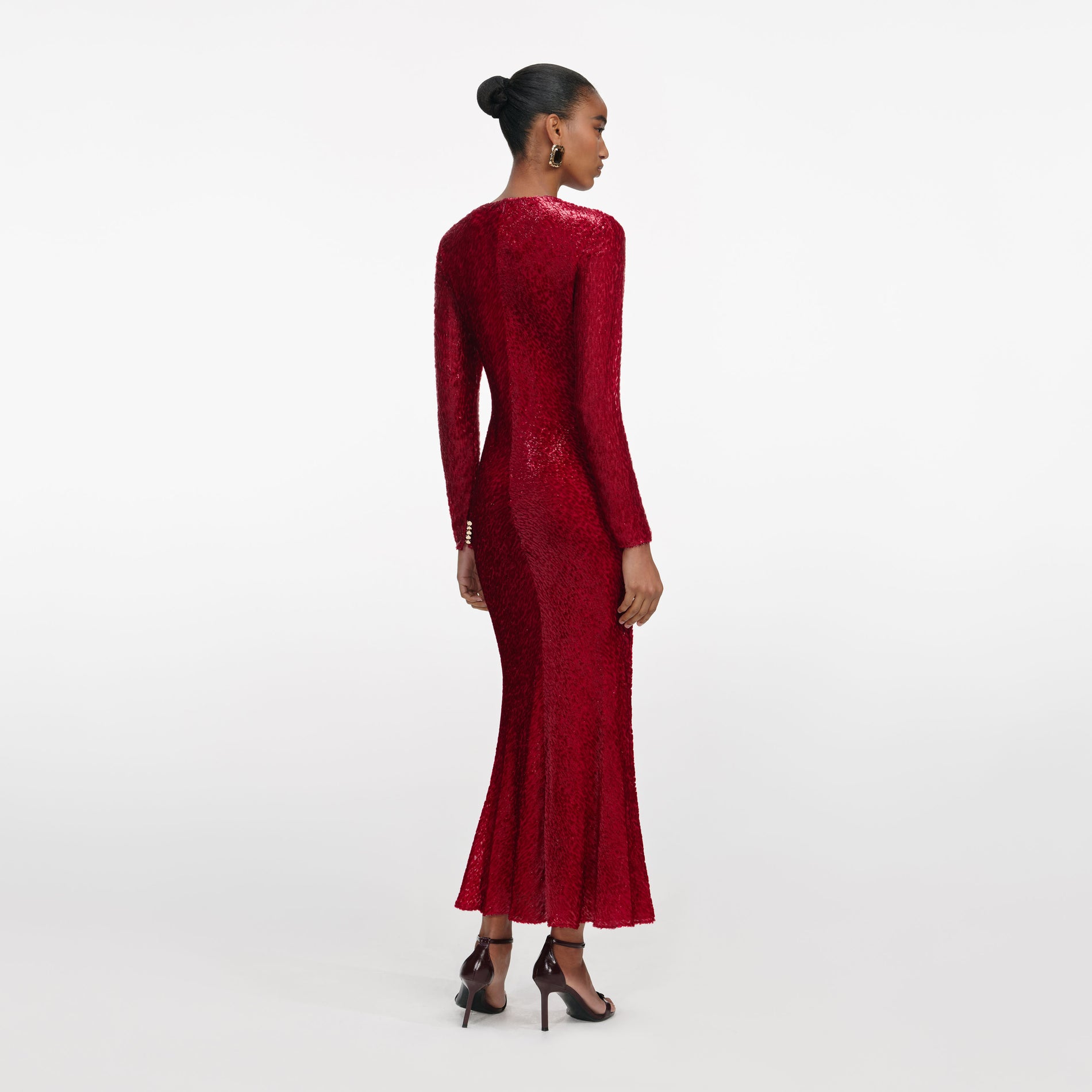 Back view of a woman wearing the Red Fil Coupe Midi Dress