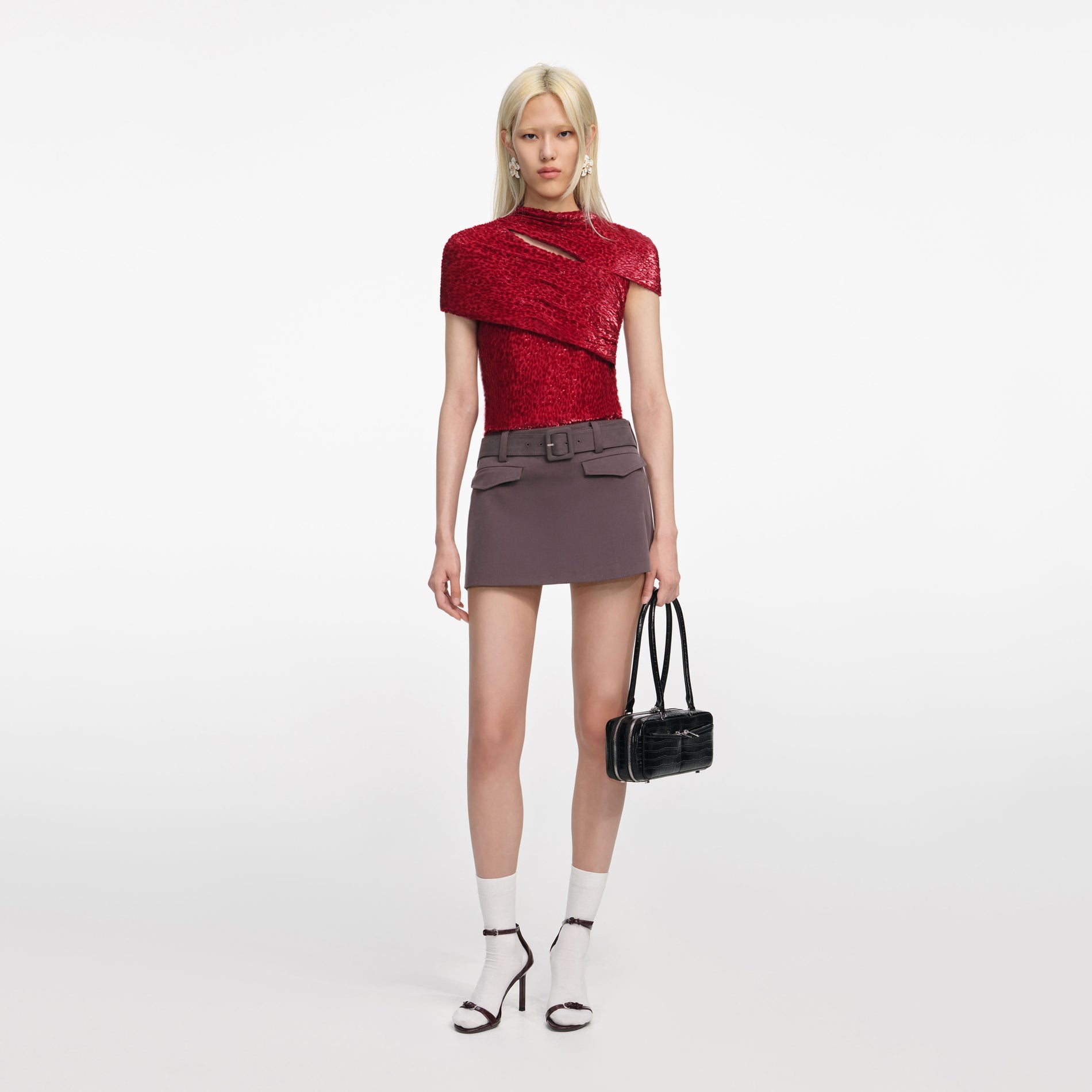 Front view of a woman wearing the Red Fil Coupe Cut Out Top