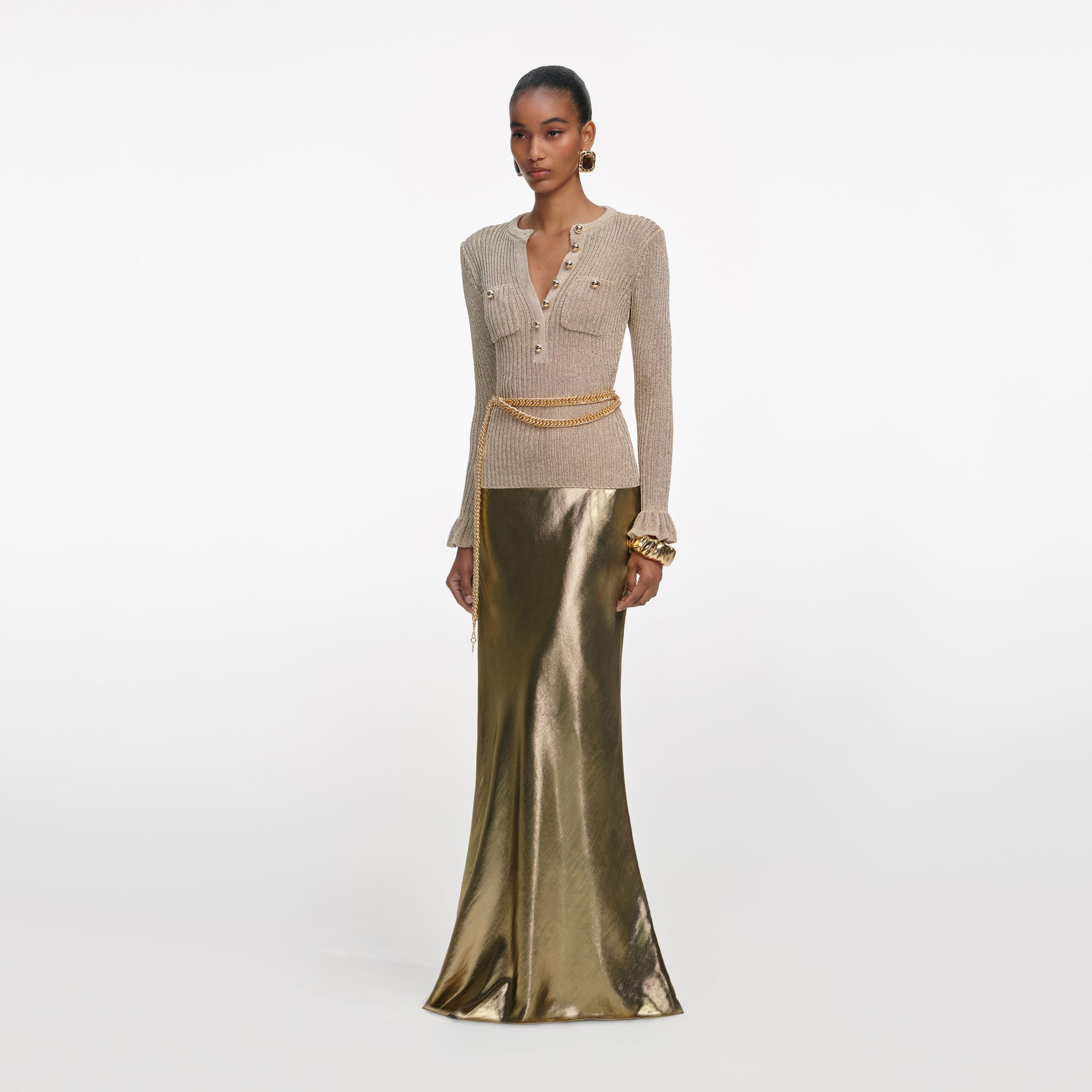 Side view of a woman wearing the Gold Metallic Maxi Skirt