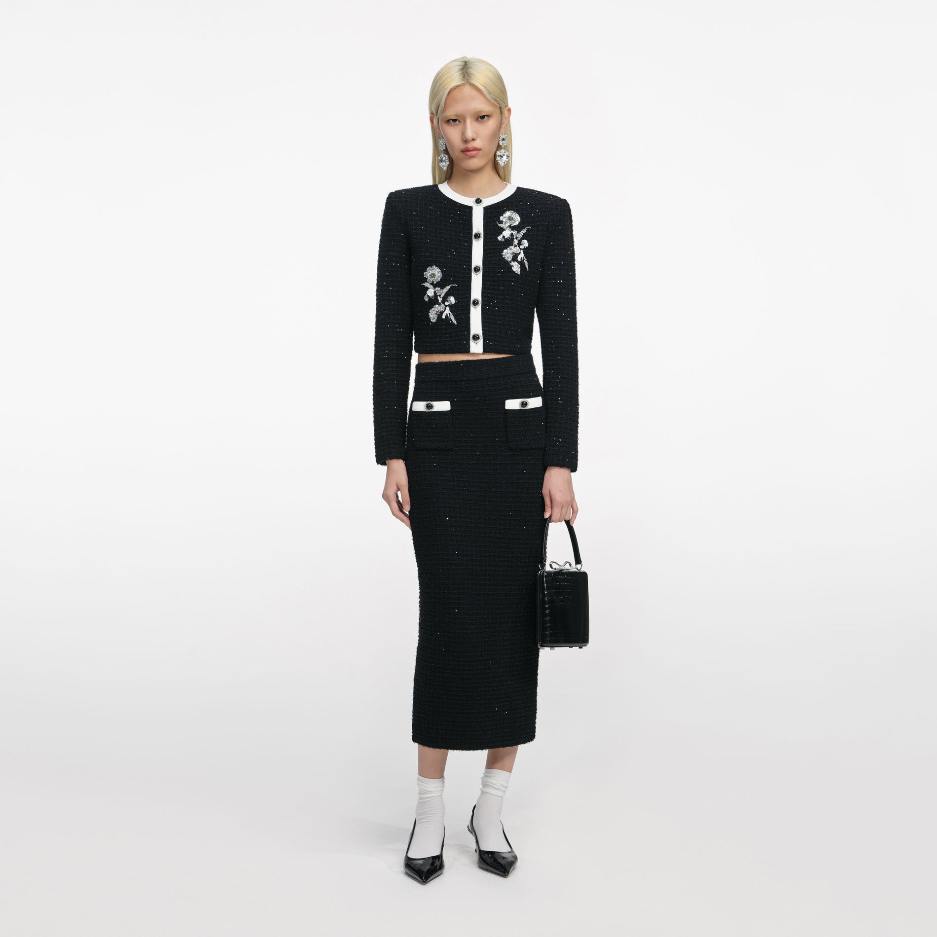 Front view of a woman wearing the Black Textured Knit Midi Skirt