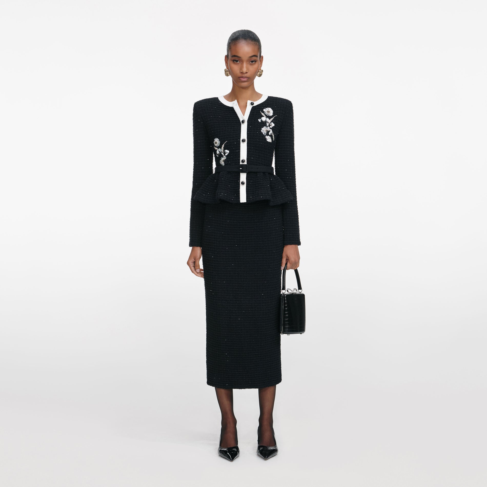 Front view of a woman wearing the Black Floral Textured Knit Midi Dress