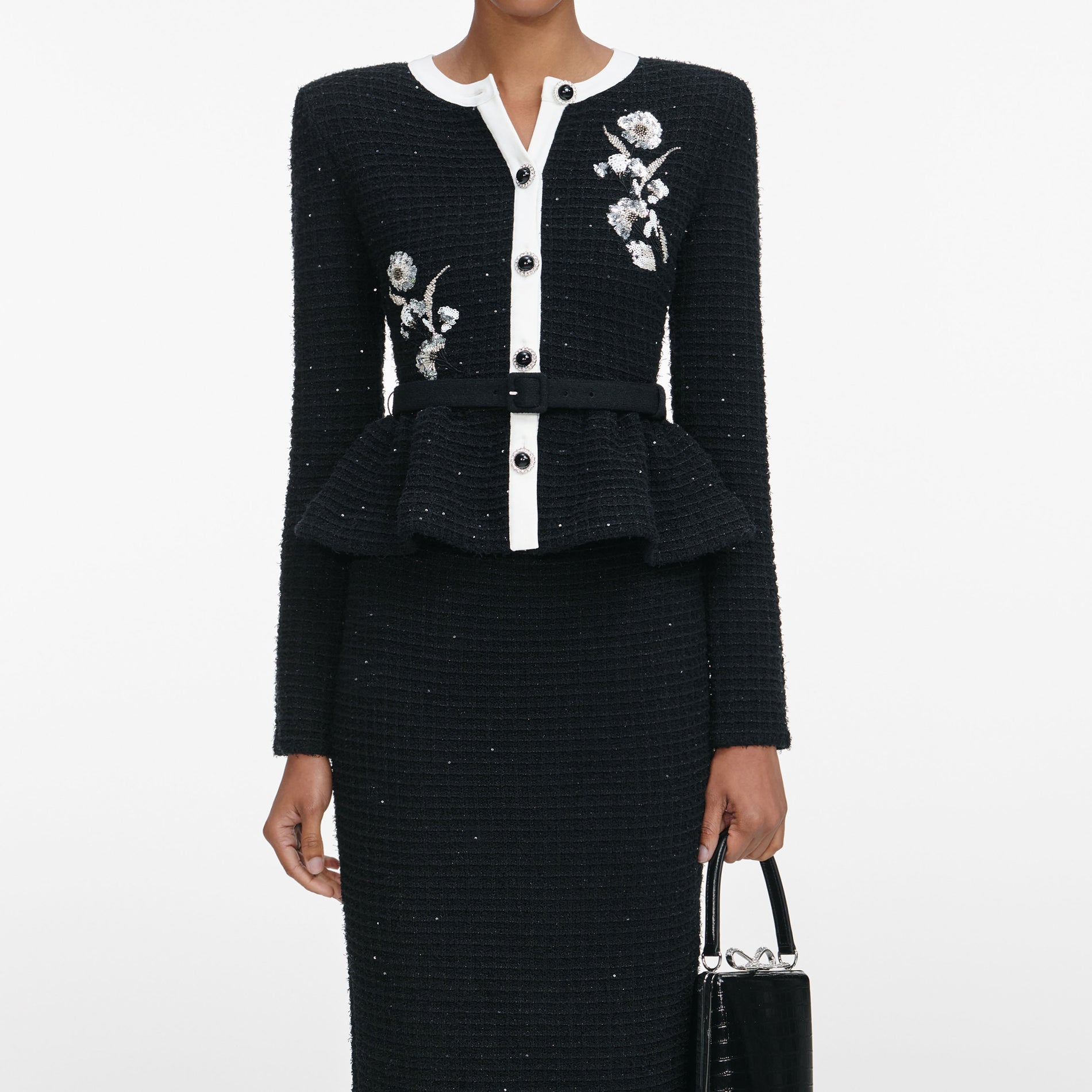 A close up of a woman wearing the Black Floral Textured Knit Midi Dress