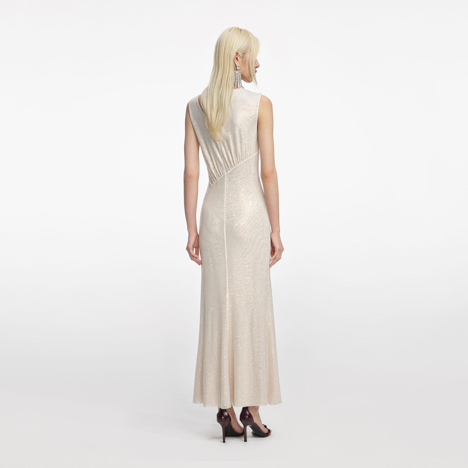 Back view of a woman wearing the Champagne Rhinestone Cut Out Midi Dress